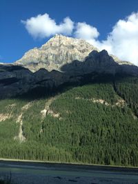 Scenic view of land and mountains against sky