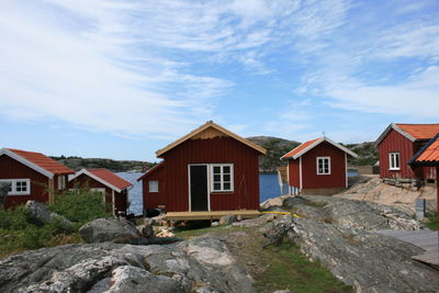 Houses against cloudy sky