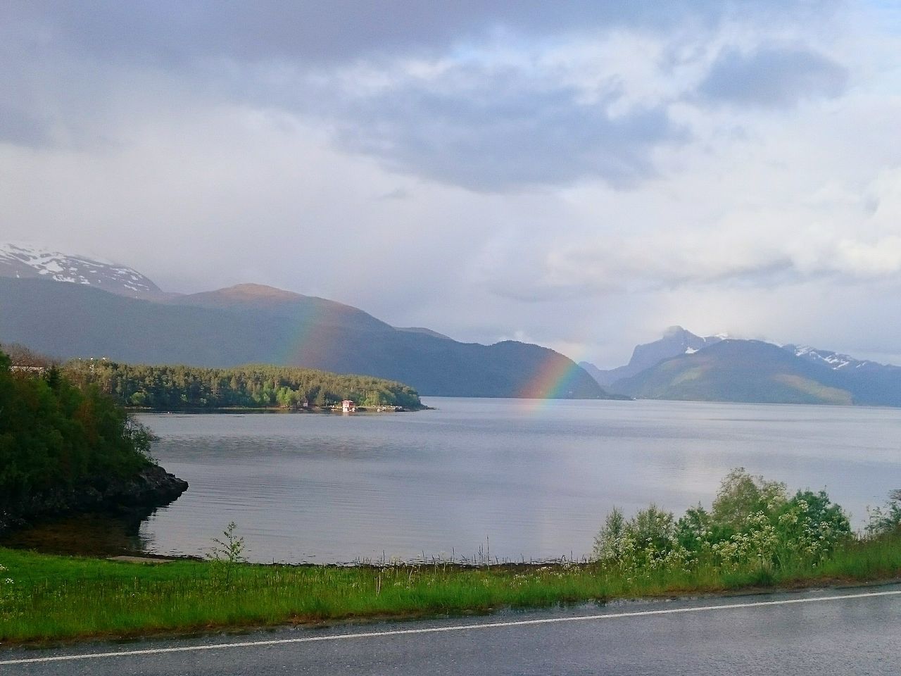 mountain, sky, water, tranquil scene, tranquility, mountain range, scenics, beauty in nature, cloud - sky, nature, lake, landscape, grass, river, road, cloud, cloudy, idyllic, plant, non-urban scene