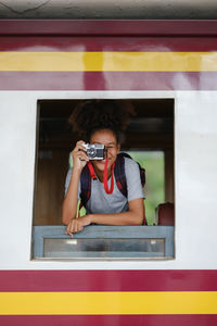 Close-up of man photographing in train