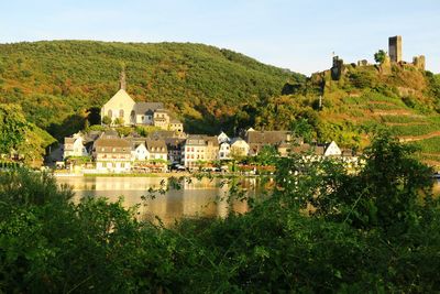 Residential district by moselle river against mountain