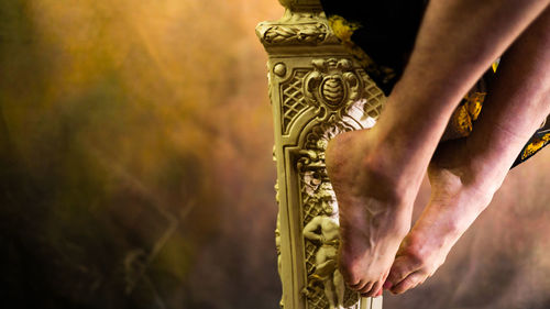 Low section of woman holding trophy