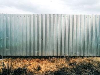 Fence on field against sky