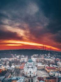 High angle view of illuminated cityscape against sky during sunset