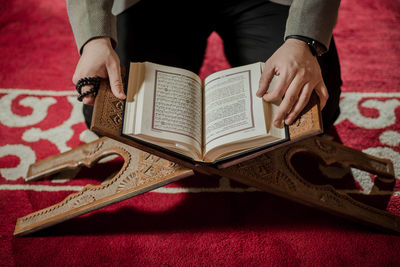 Midsection of woman reading book