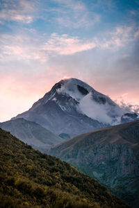 Scenic view of snowcapped mountains against sky during sunset