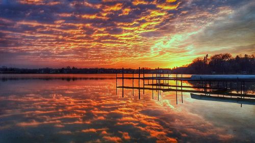 Scenic view of lake against orange sky