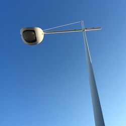 Low angle view of street light against blue sky