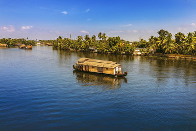 Boat in river against sky