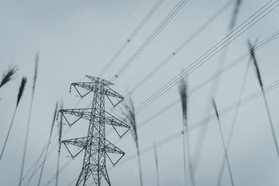 Low angle view of electricity pylon against sky