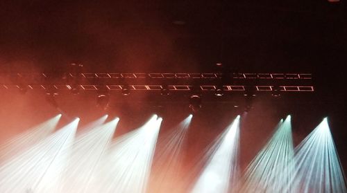 Close-up of illuminated lighting equipment against wall