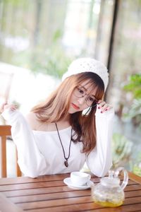 Young woman sitting on table