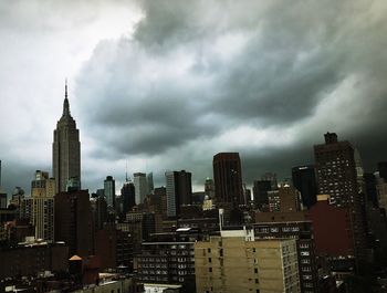 View of cityscape against cloudy sky