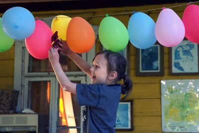 Full length of a boy holding balloons