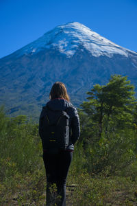 Rear view of man standing on mountain