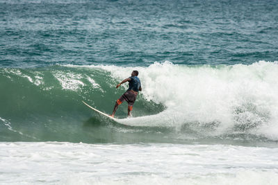 Full length of man surfing in sea