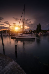 Sailboats in marina at sunset