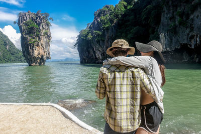 Couple standing at beach during sunny day