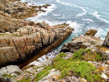 High angle view of rocks by sea