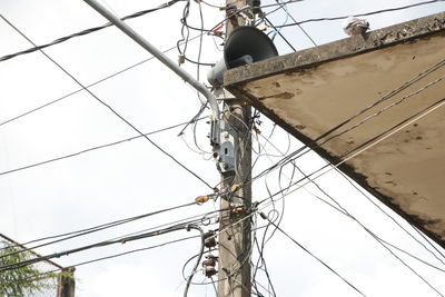 Low angle view of telephone pole against clear sky