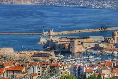 High angle view of sea and buildings in city