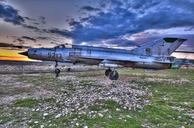 Airplane on grass against sky