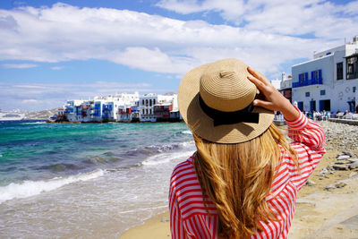 Tourist woman in little venice beach on mykonos island, greece, europe