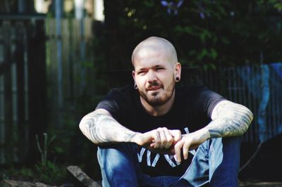 Portrait of young man sitting outdoors
