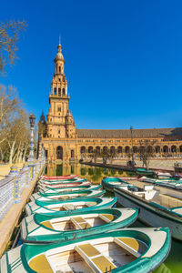 Low angle view of buildings in city against clear blue sky