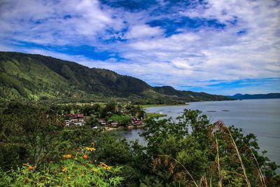 Scenic view of lake and mountains against sky