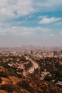 High angle view of city against cloudy sky