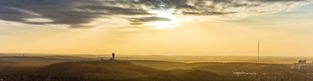 Scenic view of field against sky during sunset