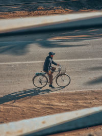 Man riding bicycle on road