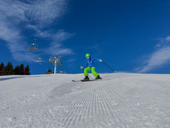 People skiing on snow covered landscape