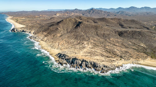 Aerial view of sea and mountains against sky