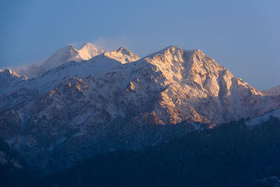 Scenic view of snowcapped mountains against clear sky