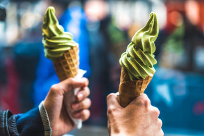 Close-up of hand holding ice cream cone