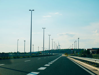 Vehicles on road against sky