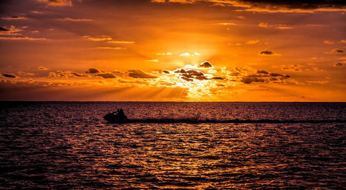 Scenic view of sea against romantic sky at sunset