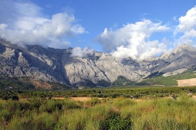 Scenic view of mountains against cloudy sky