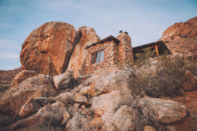 Low angle view of rock formation against sky