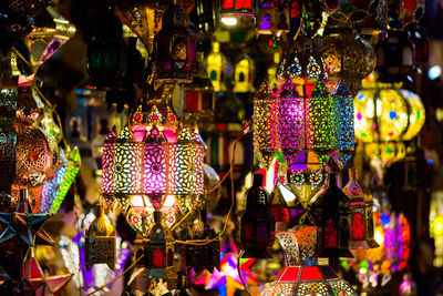 Close-up of illuminated lanterns hanging at market