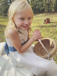 Portrait of cute girl smiling on field