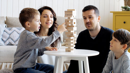 Father and daughter sitting on table