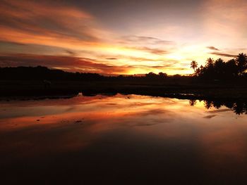 Scenic view of lake against romantic sky at sunset