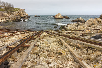 Aerial view of railroad tracks by sea against sky