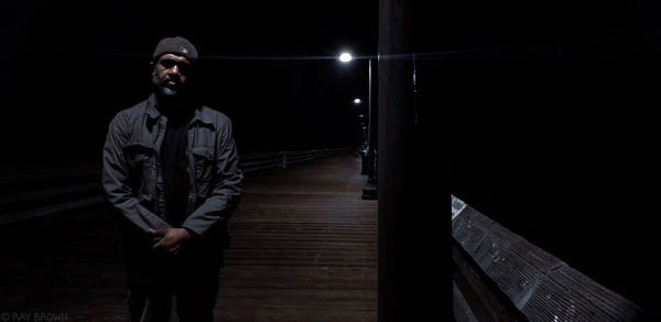 Young man standing at night