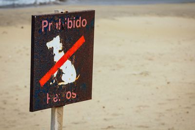 Damaged sign board at beach