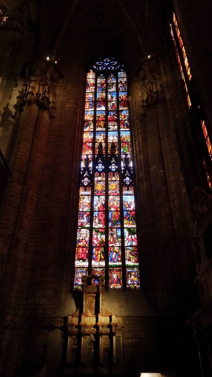 LOW ANGLE VIEW OF GLASS WINDOW IN TEMPLE