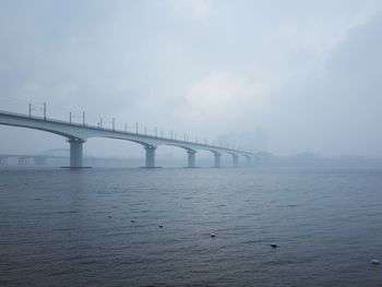 Bridge over sea against sky